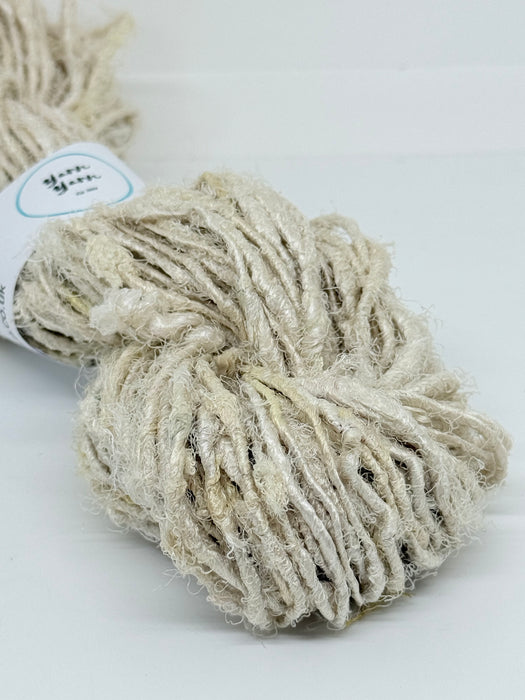 Natural white sari silk yarn.