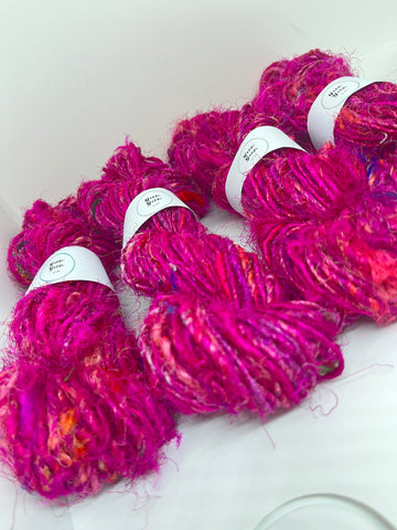 Sari silk yarn, waste silk. Handspun pure silk. Perfect pink.