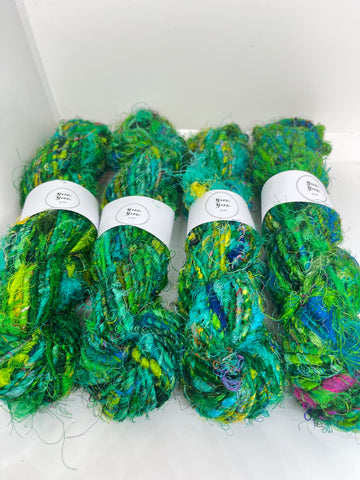 Sari silk yarn, waste silk. Handspun pure silk. Emerald green.