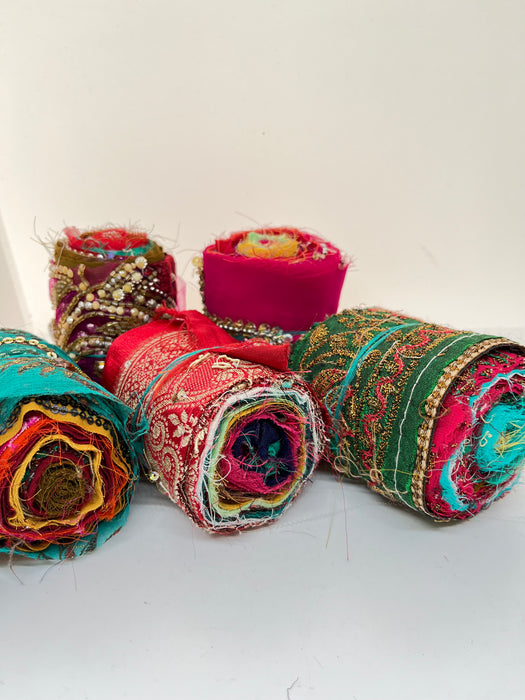 Embroidered, embellished silk rolls.