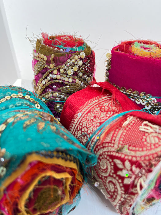 Embroidered, embellished silk rolls.