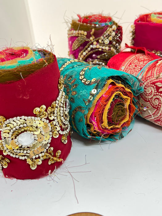 Embroidered, embellished silk rolls.