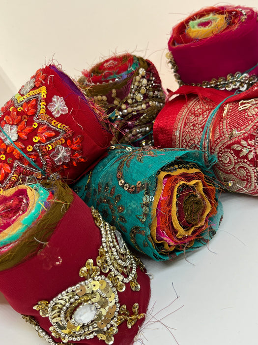 Embroidered, embellished silk rolls.